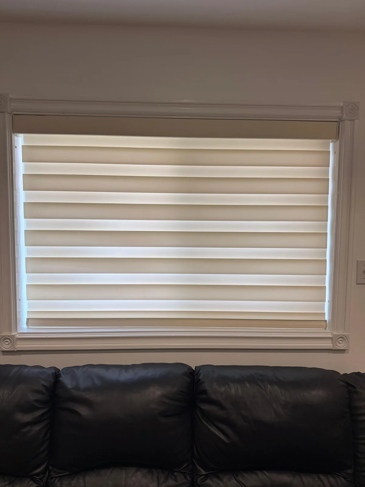 Custom layered blind installed above a sofa in Mississauga